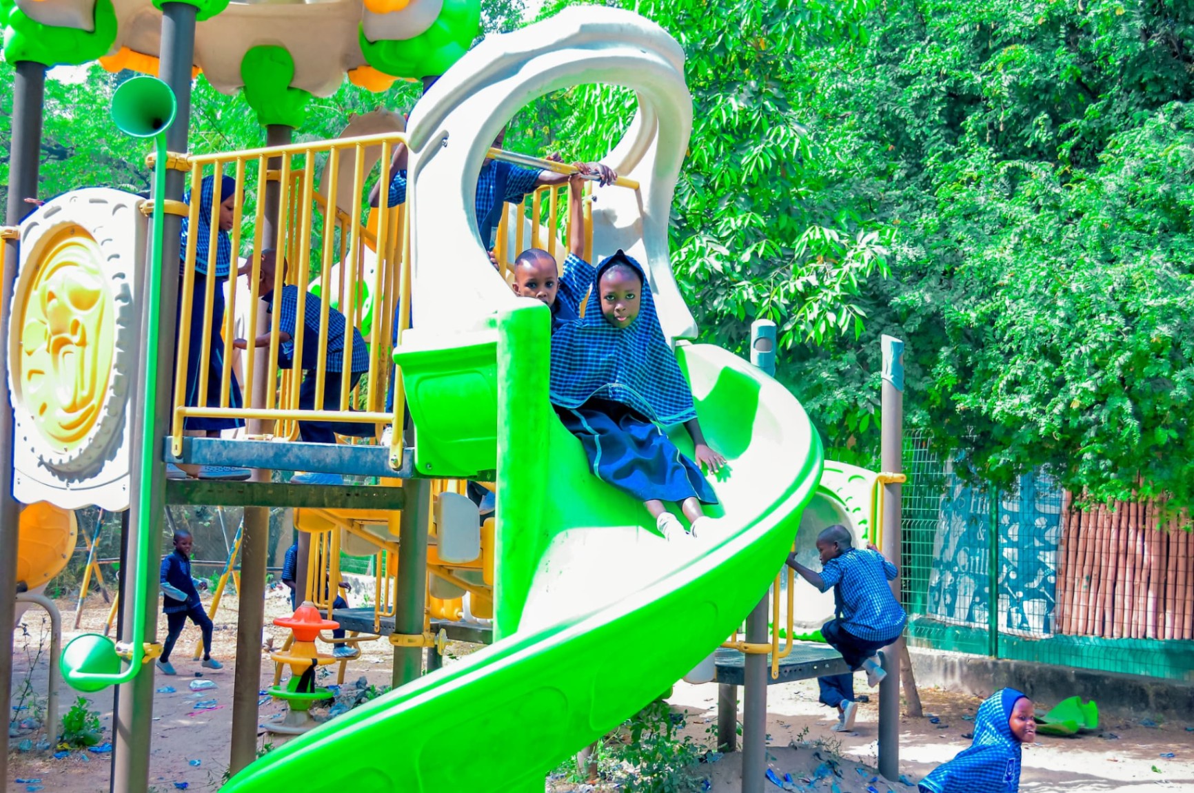 Pupils enjoying the playground slide